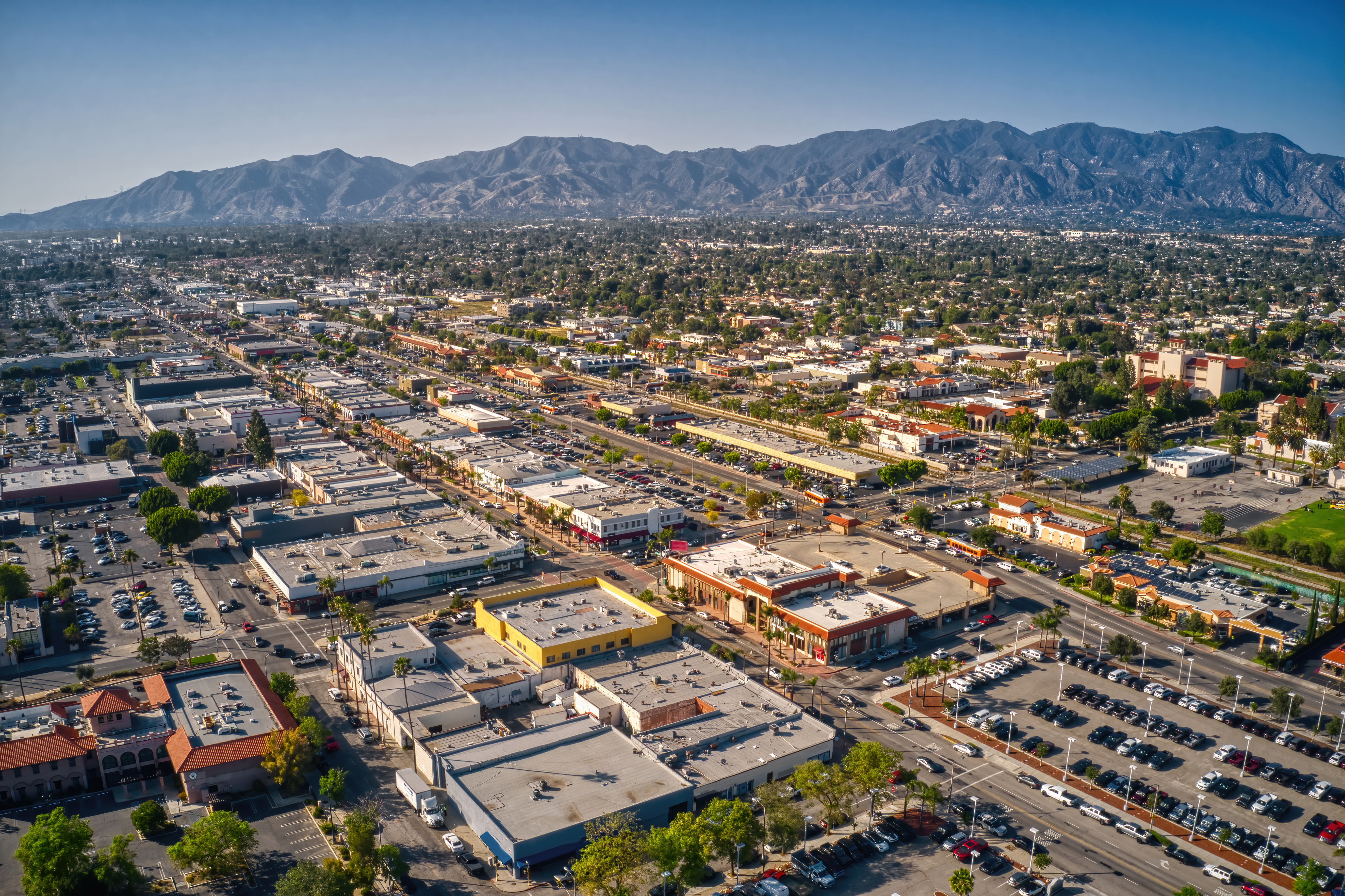 Aerial view of a Southern California commercial district with mountains in the distance